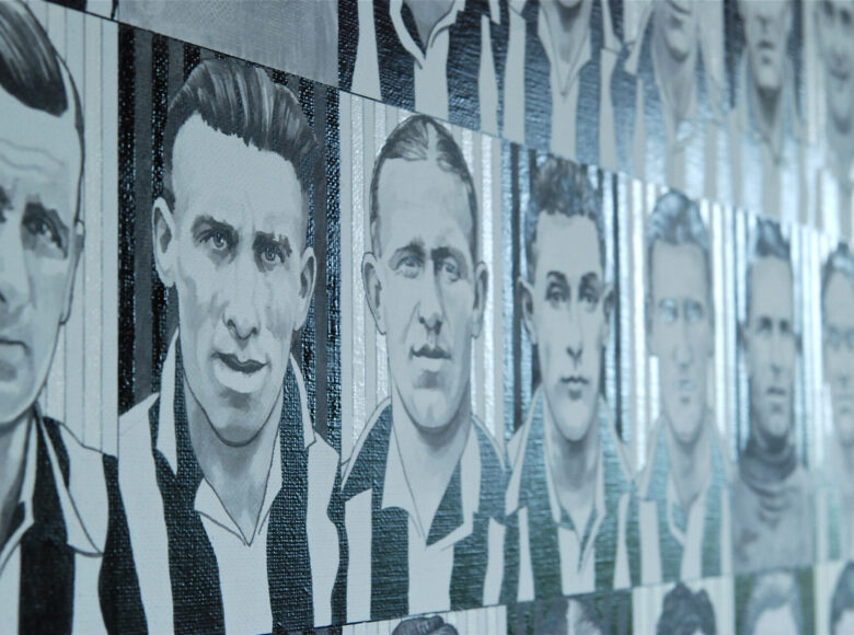 Grafika na ścianie. Składa się z namalowanych setek małych popiersi piłkarzy grupy Niukasl Junajted, którzy mają koszulki w biało-czarne pionowe pasy.